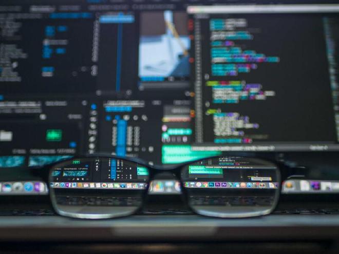 Glasses sitting on a laptop in front of the screen