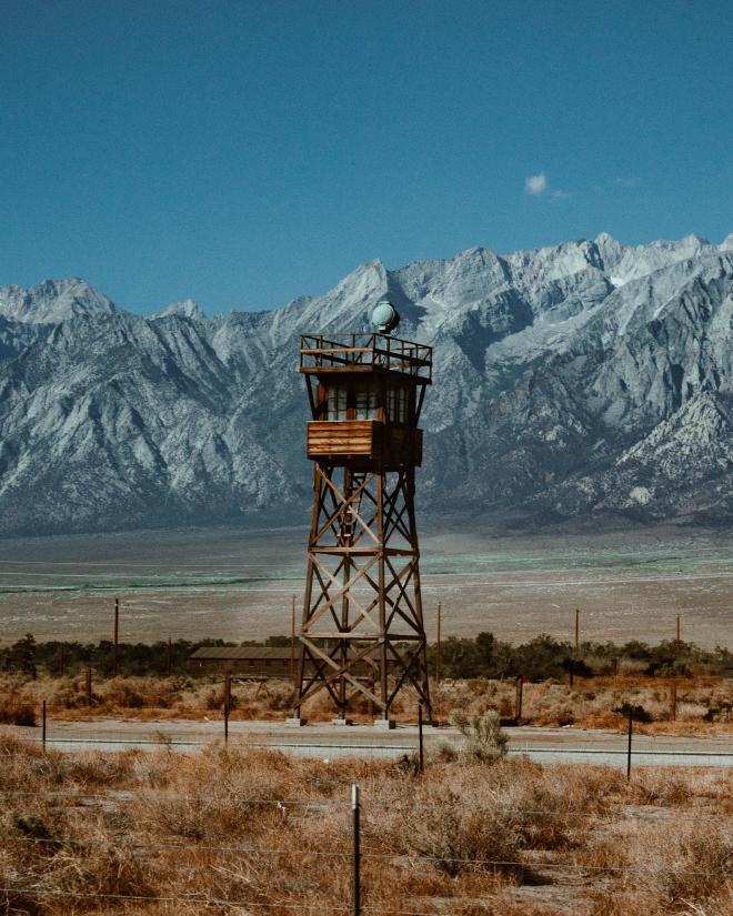 Wooden watchtower with mountains in the background